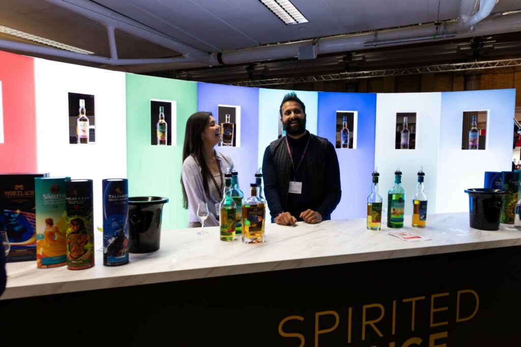 People in foreground at whiskey exhibition, with our fabricated LED display panels.