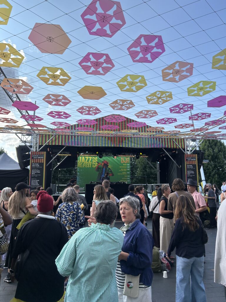 Hexagons on display in the sunshine at London's South Bank. They are suspended above people's heads whilst they dance and chat.